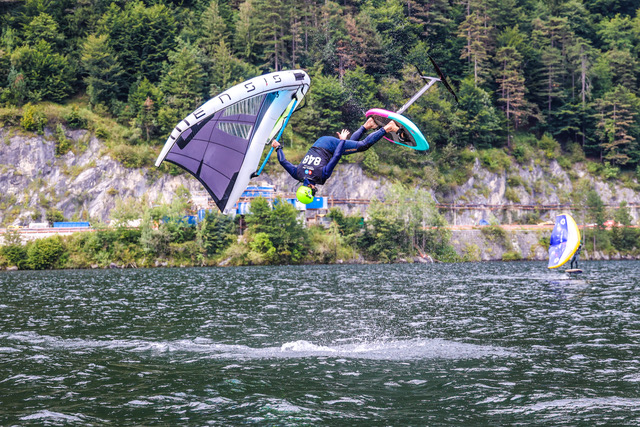 man, upside down, doing a wing foiling trick
