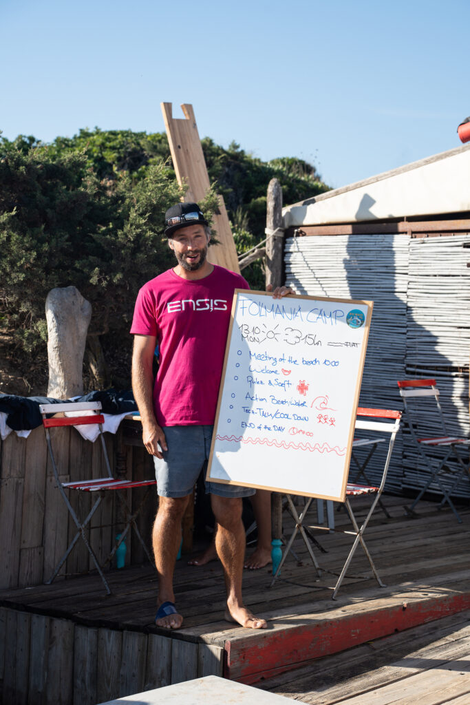 man holding foil mania camp schedule