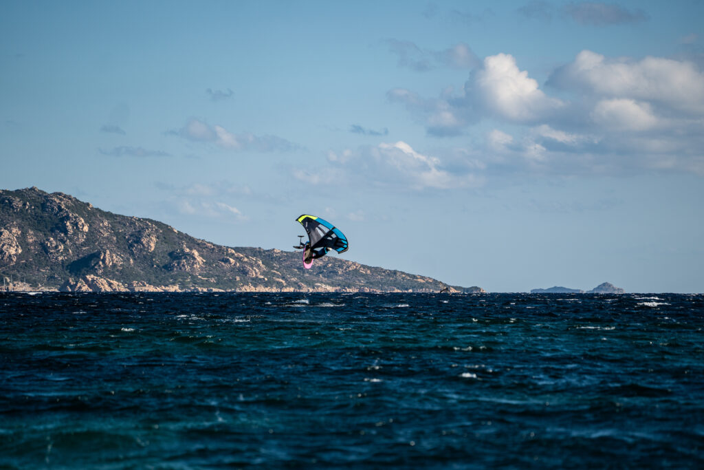 man somersaulting with wing foil